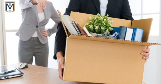 Man leaving office with belongings after being fired