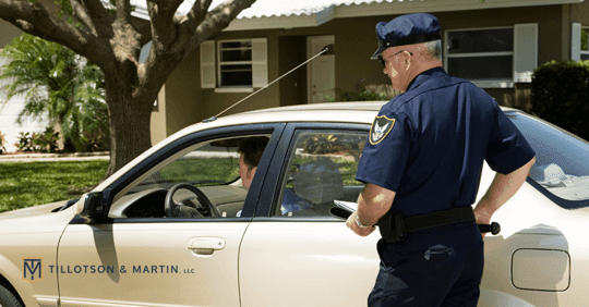 officer approaching man in car