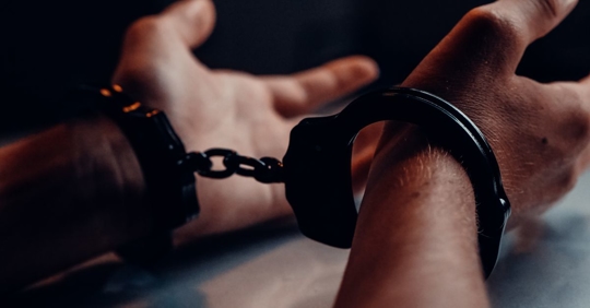 man's handcuffed hands