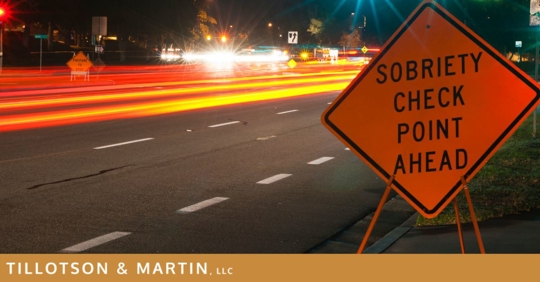 sobriety checkpoint sign on road at night