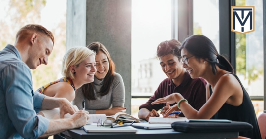 group of young students sitting at a table