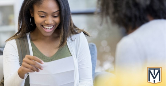 girl happy looking at a piece of paper